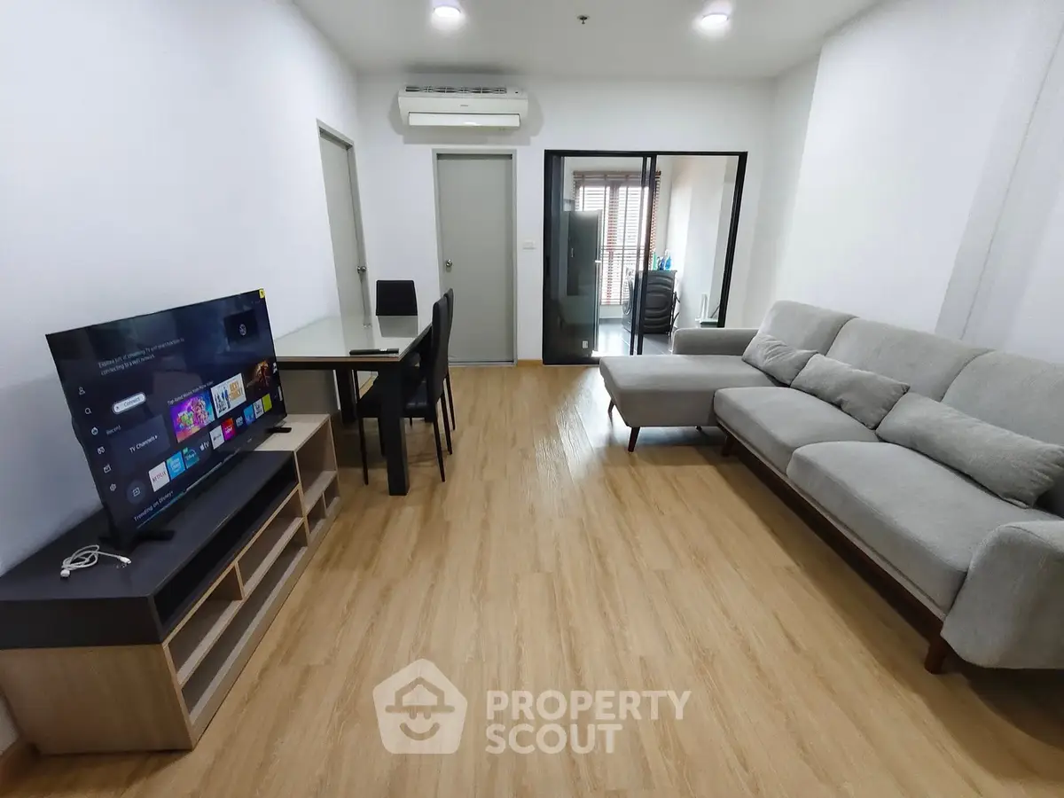Modern living room with sleek furniture and entertainment setup, perfect for relaxation and gatherings.