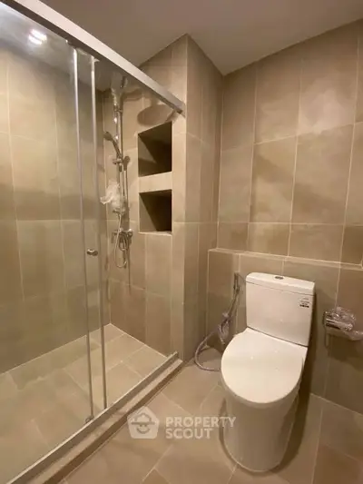 Modern bathroom with glass shower and sleek tile design