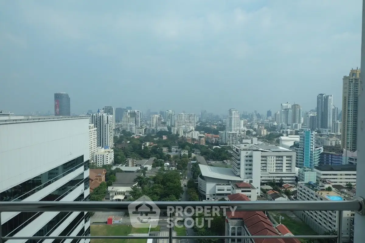 Stunning cityscape view from a high-rise balcony showcasing urban skyline and modern architecture.
