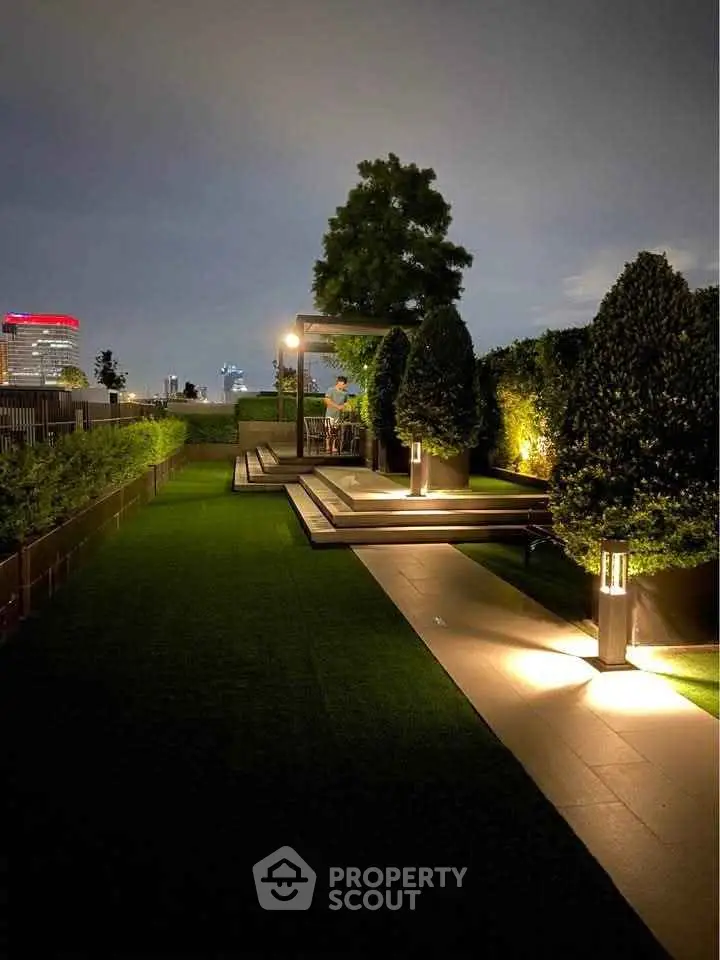 Luxurious rooftop garden with ambient lighting and city views, perfect for relaxation and entertainment.