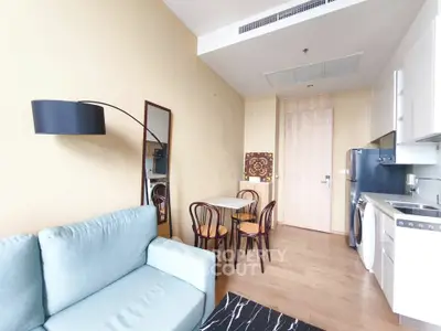 Modern apartment interior with cozy living area and compact kitchen