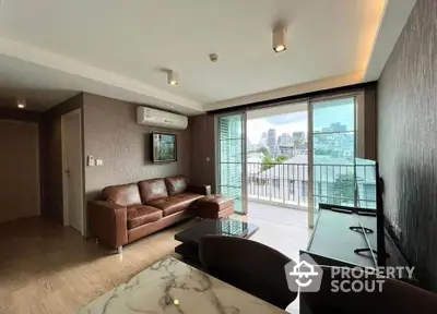 Modern living room with city view and leather sofa in high-rise apartment