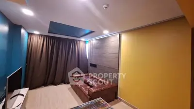 Modern living room with leather sofa and vibrant wall colors