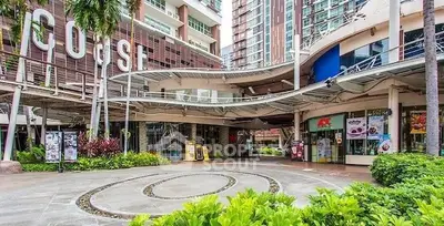 Modern commercial building exterior with lush landscaping and unique architectural design.