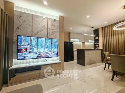 Luxurious modern living room with marble accents and open kitchen layout.