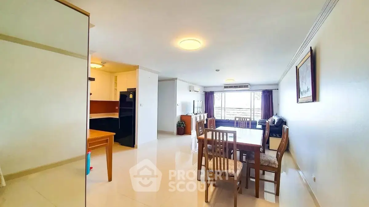 Spacious living and dining area with modern furnishings and natural light.