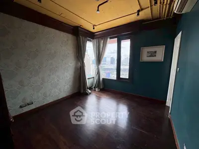 Spacious corner unit with large windows offering stunning city views, perfect for a stylish living room setup.