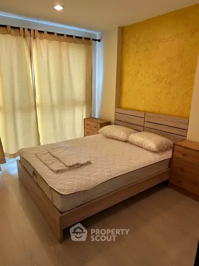 Cozy bedroom with natural light and stylish wooden furniture