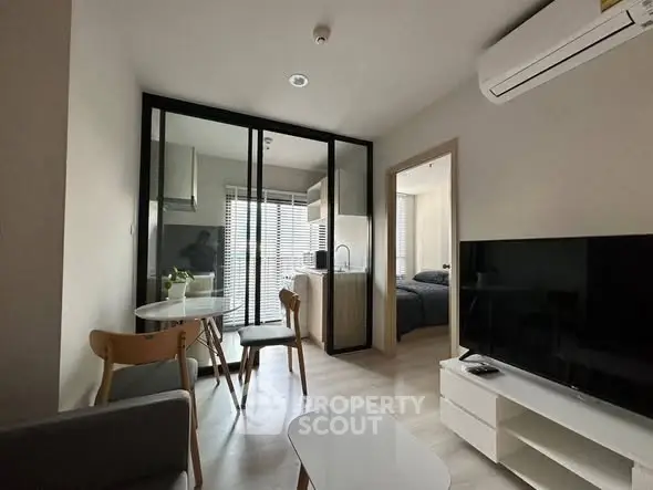 Modern apartment interior with open layout, featuring a cozy living area and stylish kitchen.