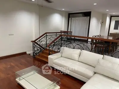 Spacious living room with elegant staircase and modern furniture