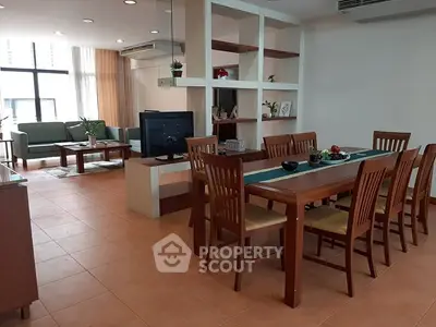 Spacious open-plan living and dining area with modern furniture and natural light.