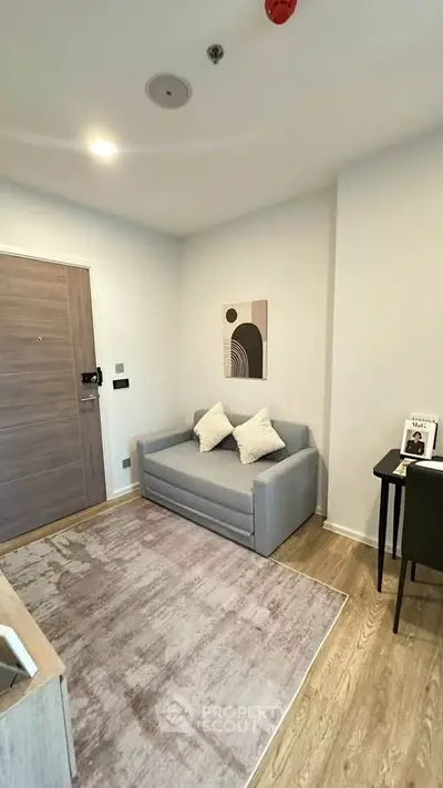 Modern living room with cozy gray sofa and stylish decor