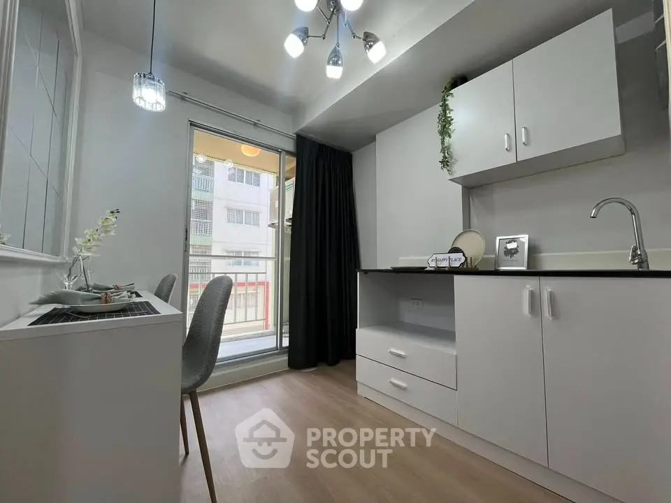 Modern kitchen with sleek white cabinets and natural light, perfect for urban living.
