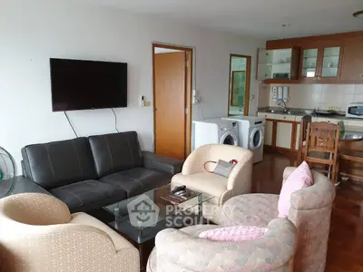 Spacious living room with modern furniture and open kitchen layout