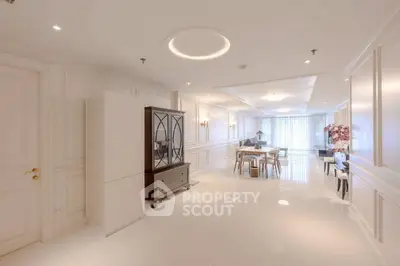 Luxurious open-plan living room with elegant decor and abundant natural light.