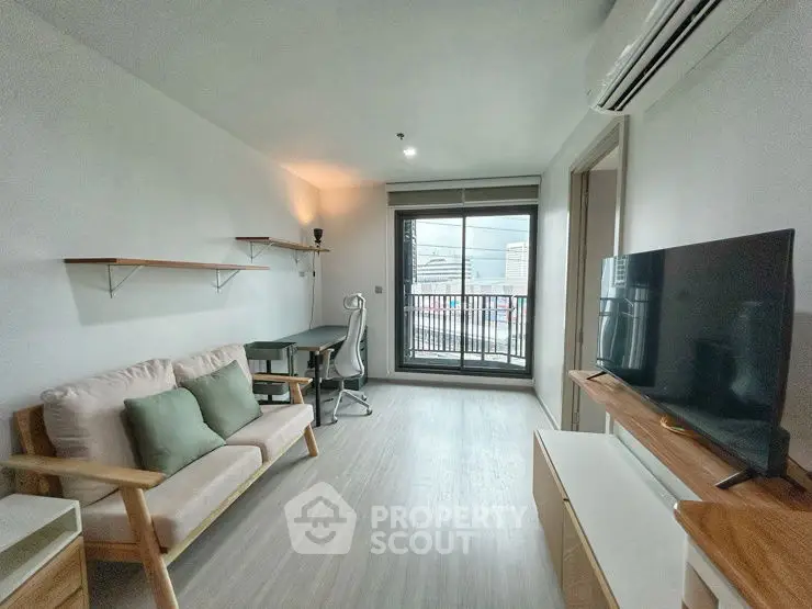 Modern living room with balcony view, featuring sleek furniture and natural light.
