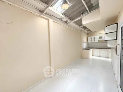 Spacious kitchen with open layout and modern fixtures in bright, airy room.