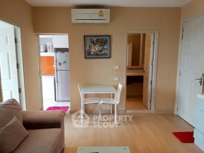 Cozy living room with modern furniture and kitchen access