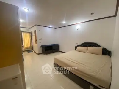 Spacious bedroom with modern furnishings and ample natural light