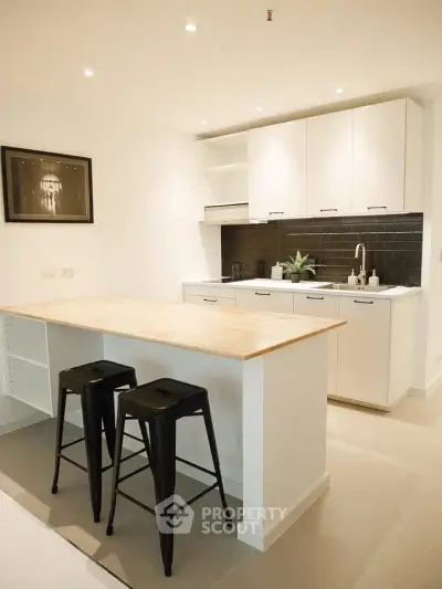 Modern kitchen with sleek white cabinets and stylish black backsplash