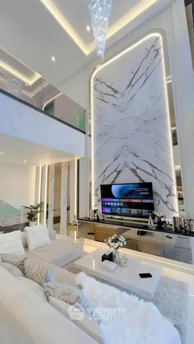 Luxurious modern living room with high ceilings and elegant marble wall design