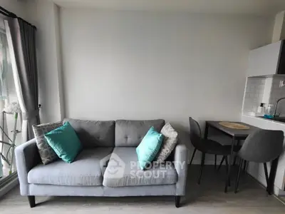 Modern living room with stylish grey sofa and dining area, perfect for urban living.