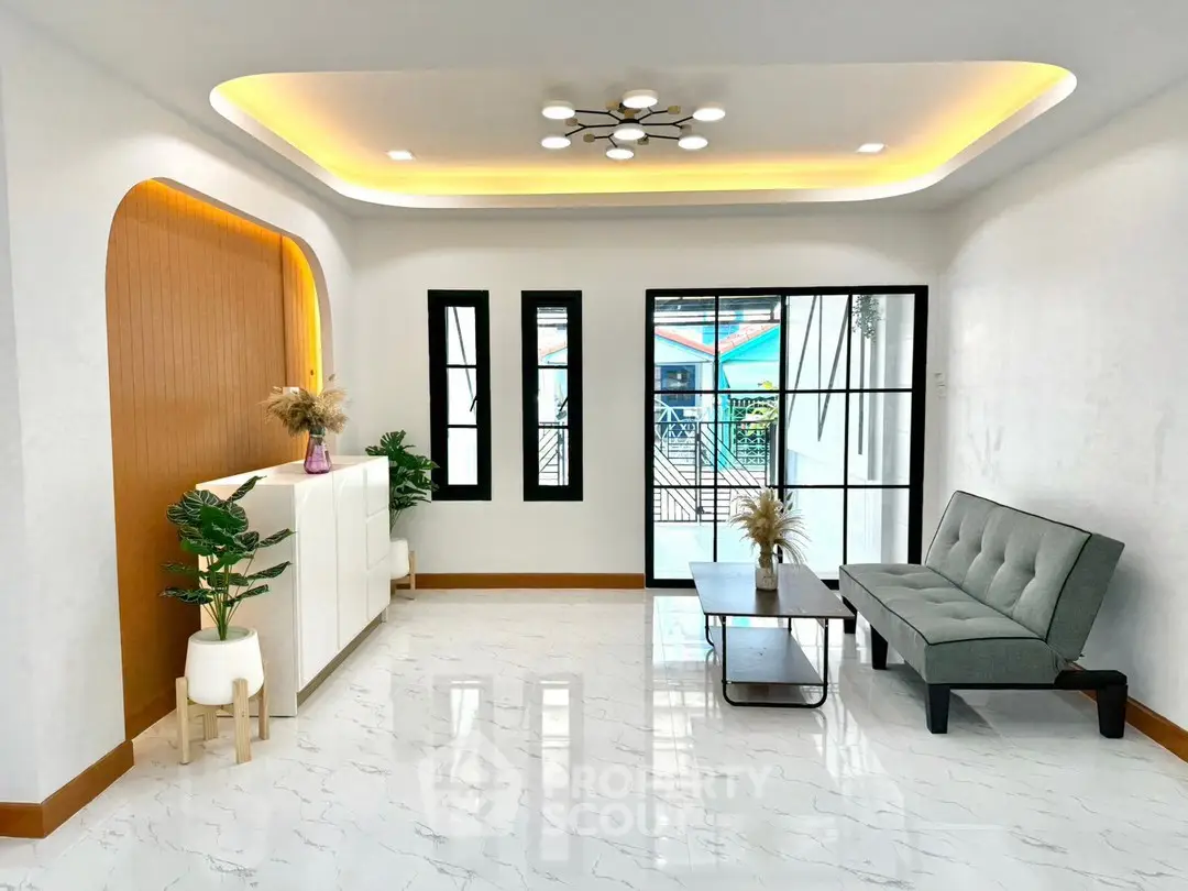 Modern living room with stylish decor and large windows offering natural light.