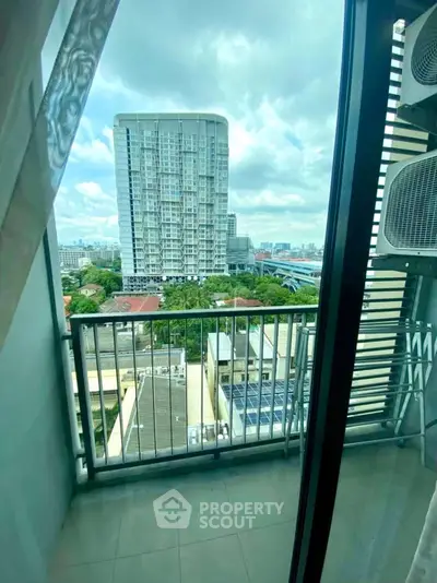 Stunning city view from a modern apartment balcony with glass railing.