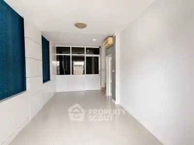 Spacious unfurnished room with modern design and large windows, perfect for customization.