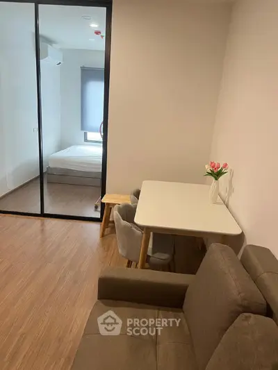 Modern apartment with cozy living area and glass partitioned bedroom