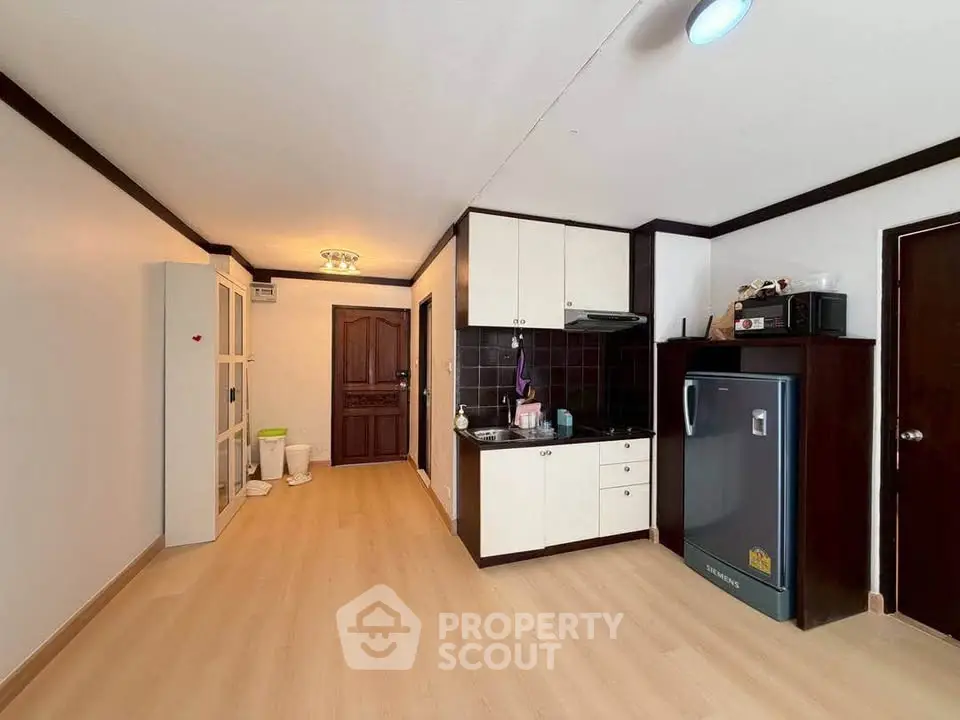 Spacious kitchen with modern appliances and ample storage in a stylish apartment.