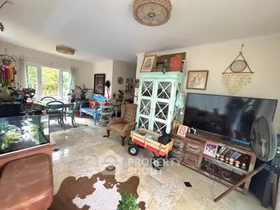 Charming living room with eclectic decor and natural light, featuring a cozy seating area and stylish furnishings.