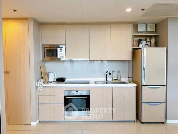 Modern kitchen with sleek cabinetry and built-in appliances in a stylish apartment.