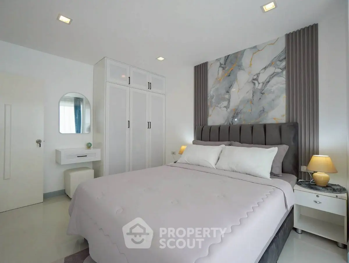 Elegant bedroom with modern decor and stylish marble accent wall
