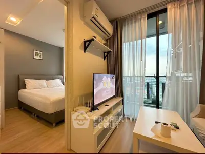 Modern apartment with cozy living room and bedroom, featuring a balcony with city view.