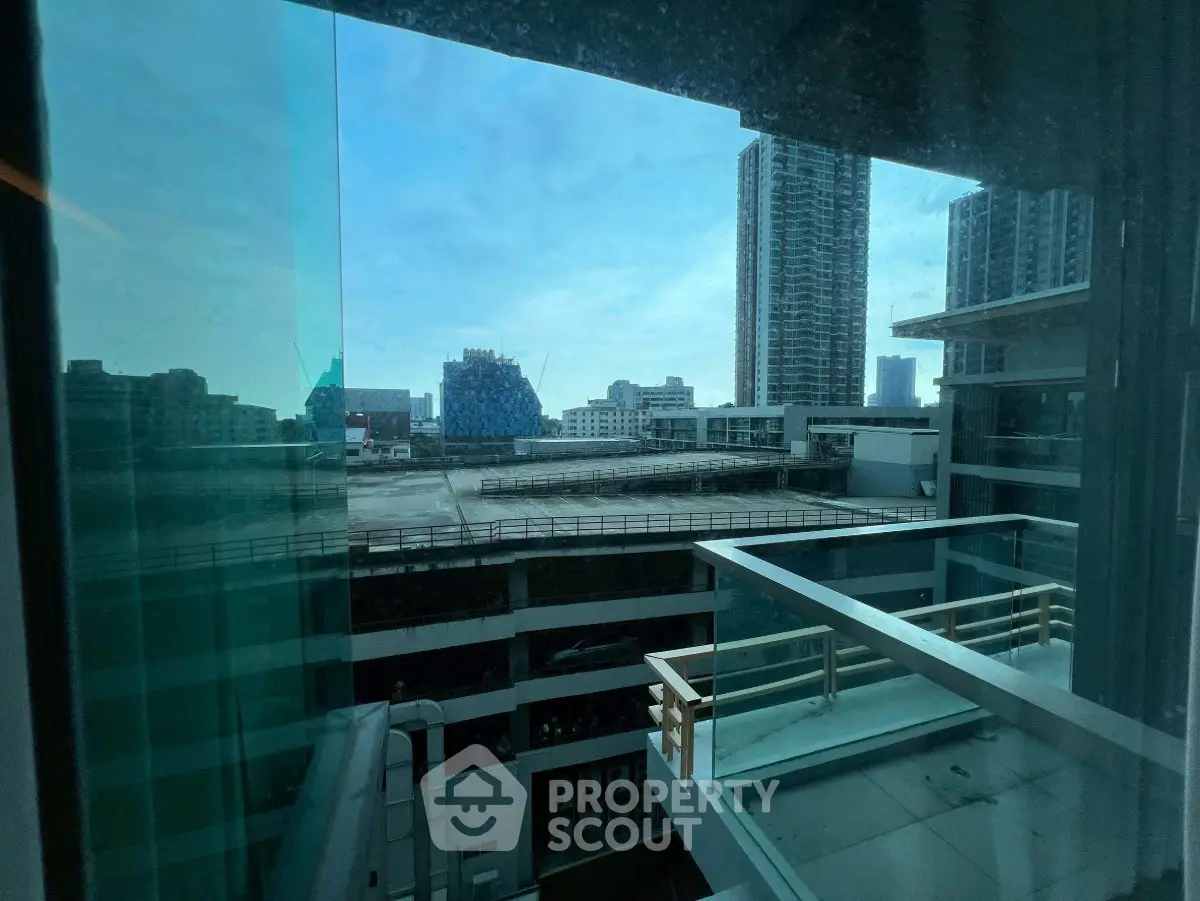 Stunning urban view from high-rise balcony showcasing city skyline and modern architecture.