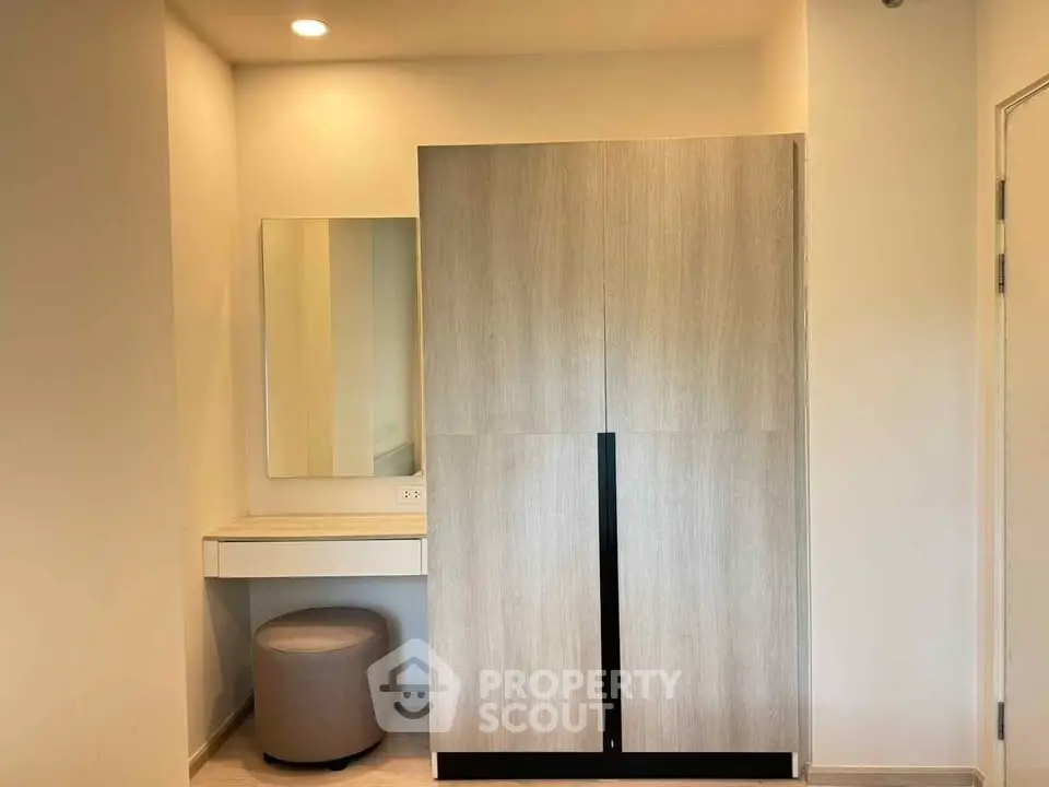Modern bedroom with sleek wardrobe and vanity in minimalist design