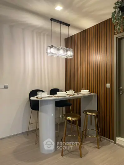 Modern kitchen with stylish bar seating and elegant lighting