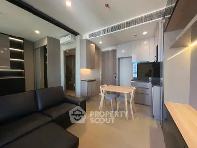 Modern open-plan living room with sleek kitchen and stylish furniture