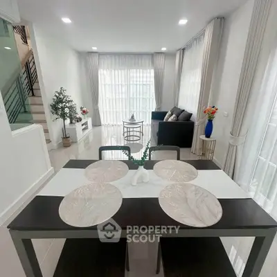 Modern open-plan living and dining area with elegant decor and natural light