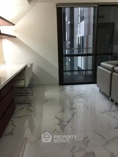 Modern living room with marble flooring and balcony view in luxury apartment.