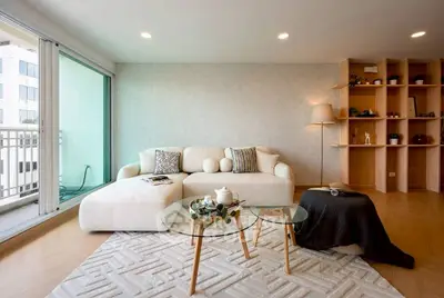 Modern living room with stylish decor and large windows for natural light.