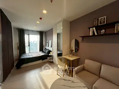 Modern studio apartment with stylish decor and city view, featuring cozy living area and elegant bedroom.