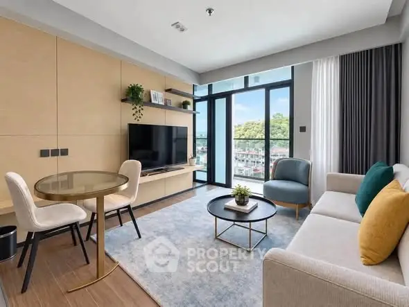 Modern living room with large windows and stylish furniture, offering a bright and inviting atmosphere.