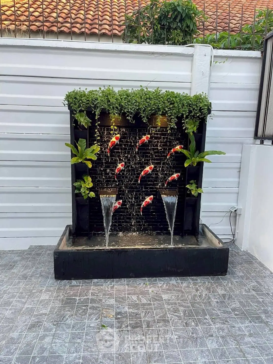 Elegant garden water feature with koi fish and lush greenery