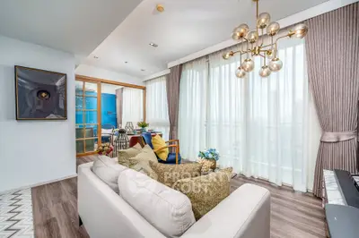 Luxurious living room with elegant decor and floor-to-ceiling windows in modern apartment.
