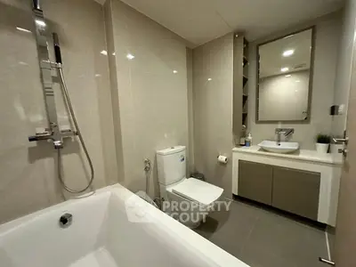 Modern bathroom with sleek fixtures and bathtub in contemporary apartment.