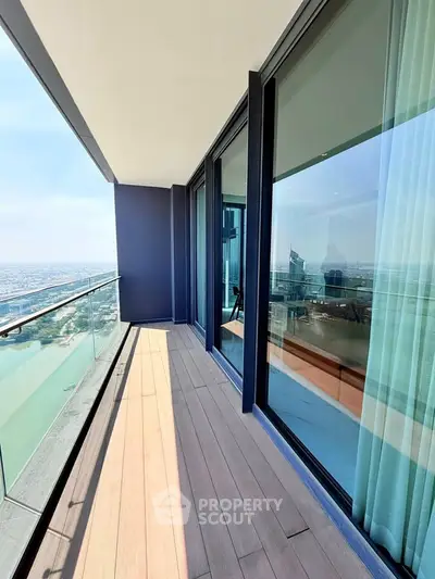 Stunning high-rise balcony with breathtaking city and water views, perfect for relaxation and entertainment.