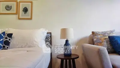 Cozy bedroom with stylish decor and comfortable seating area