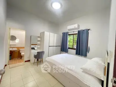 Cozy bedroom with ensuite bathroom and modern furnishings